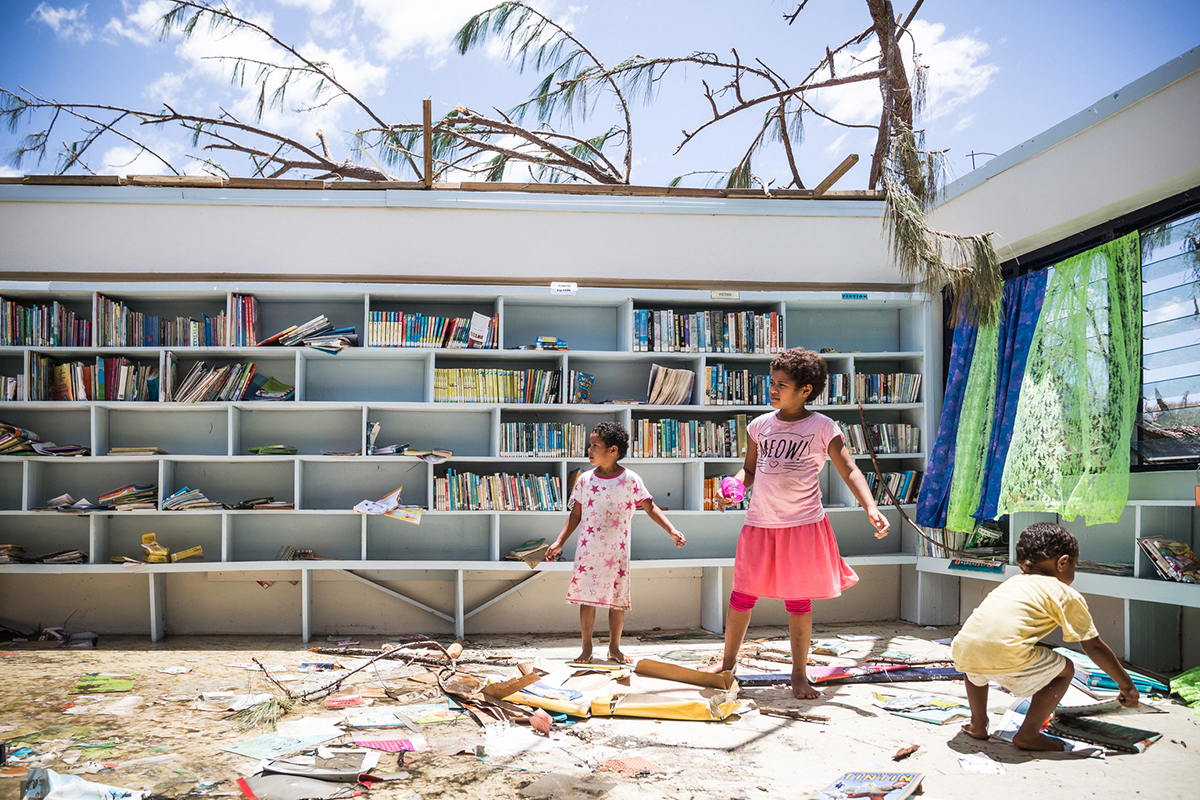 In the aftermath of Cyclone Winston, children play in what remains of a school library in the northern Ra province of Fiji (Photo: UNICEF/Vlad Sokhin).